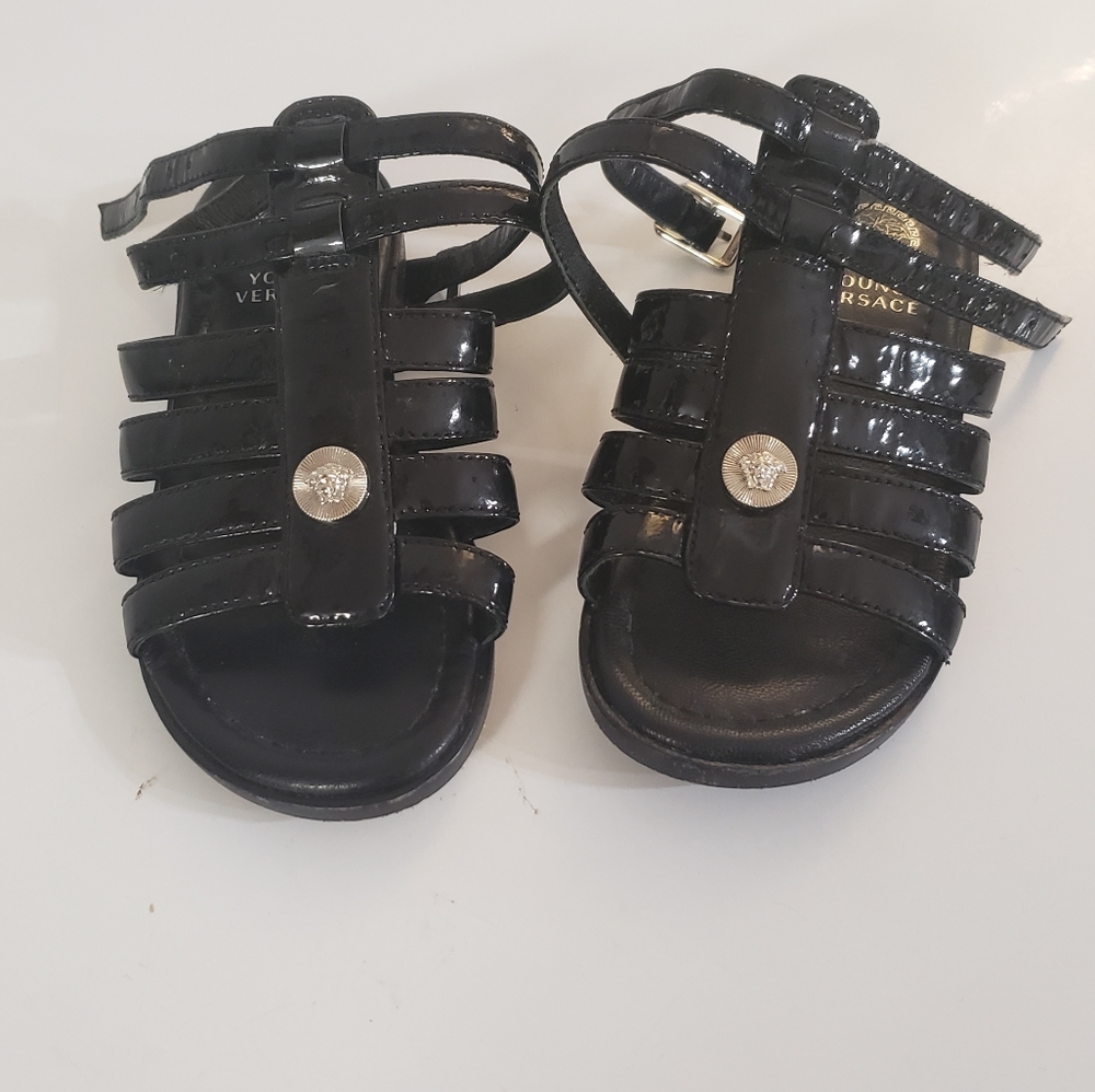 Young Versace sandals. Toddler girls black size 8. Strap around the ankle.